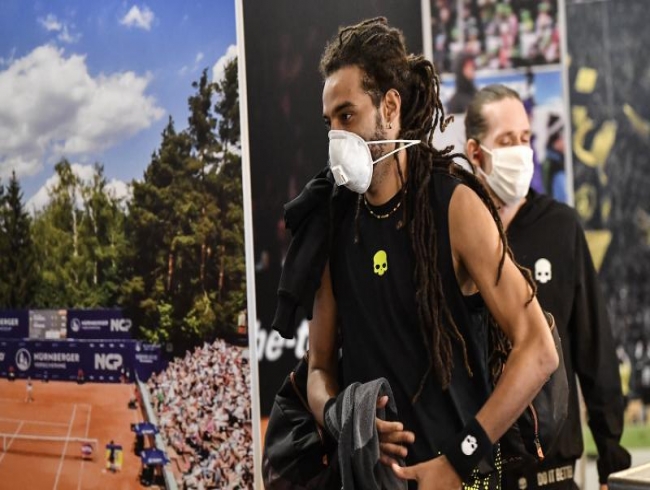 Dustin Brown's masked men bring tennis back to sound of silence